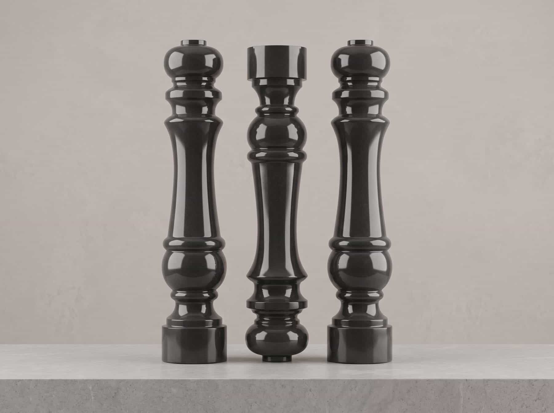 Three turned black granite columns standing side by side