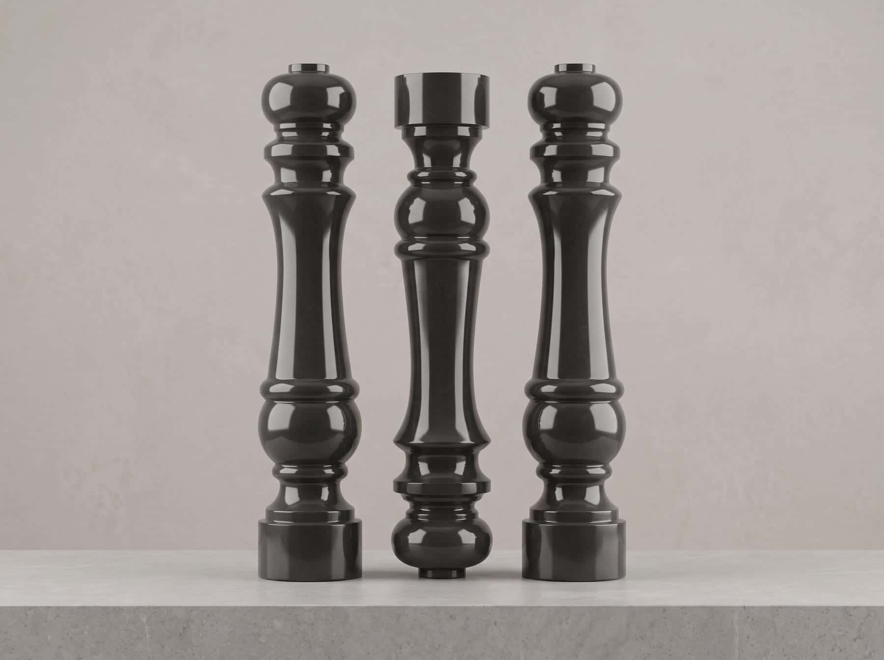 Three turned black granite columns standing side by side