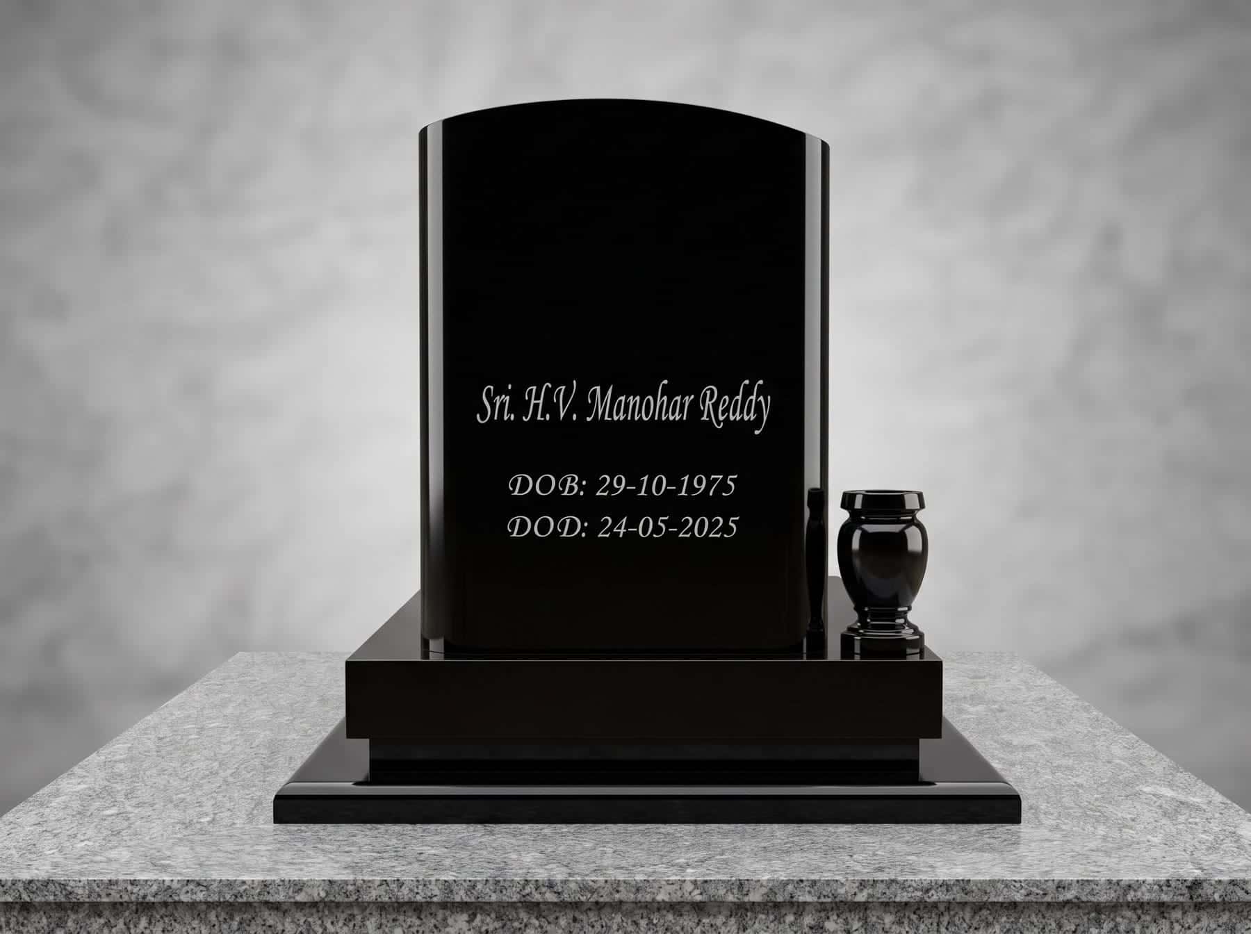 Engraved black granite headstone with a granite vase on a grey granite plinth