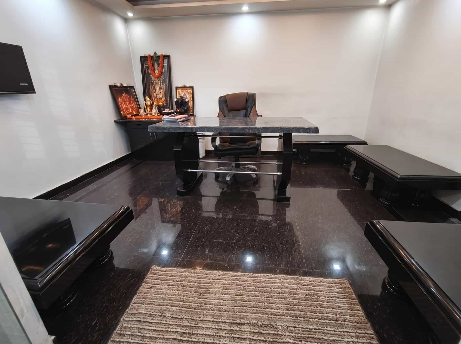 Interior room with polished dark granite flooring and granite furniture